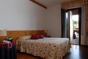 Postel nebo postele na pokoji v ubytování Hotel Albergo Dolomiti