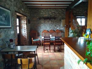 a restaurant with a table and chairs in a room at Casa Albertino in El Tejo