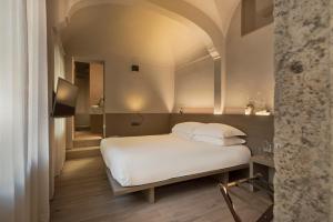 Säng eller sängar i ett rum på Hotel dei Barbieri