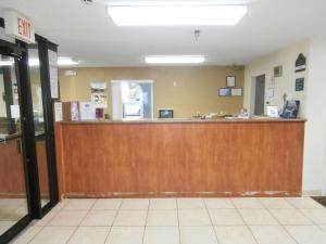 an empty waiting room with a large wooden bar at Country Hearth Inn & Suites Dawson in Dawson