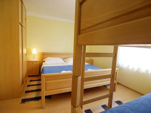 a bedroom with a bunk bed with a blue bed at Apartments Barbara in Banj