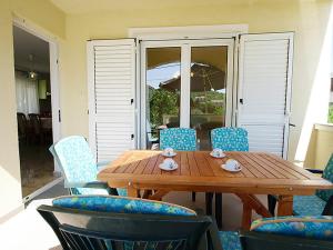a wooden table with chairs and a tableasteryasteryasteryasteryasteryasteryasteryastery at Apartments Barbara in Banj +31 photos