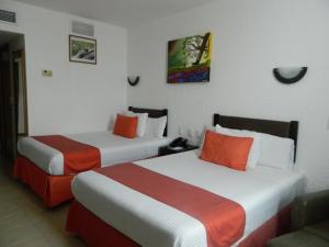 Postel nebo postele na pokoji v ubytování Hotel Enriquez + 12 fotografií