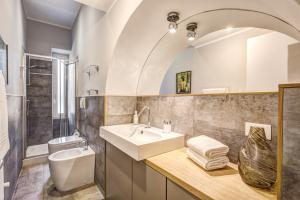 a bathroom with a sink and a toilet at Cinque Terre Stylish Apartments in La Spezia