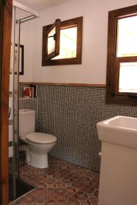 a bathroom with a toilet and a sink at El Balcón del Huéznar in Cazalla de la Sierra