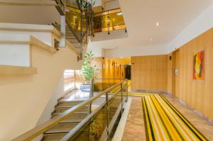 a hallway with a yellow escalator in a building at Hotel Alvorada in Estoril