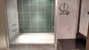 a shower with a glass door in a bathroom at Flat no Hotel Mountain Village in Canela