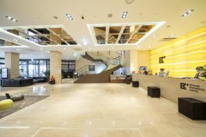 a lobby of a building with a reception counter at Busan Business Hotel in Busan