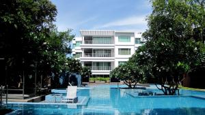 a swimming pool in front of a building at Baan Sandao by Nanni in Hua Hin