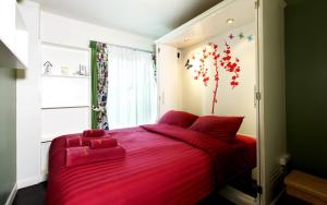 a bedroom with a red bed with a red blanket at Baan Sandao by Nanni in Hua Hin +38 photos