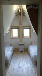 a room with three beds and two windows at WillowTree Cottage in Avèze