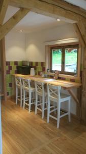 a kitchen with a large wooden table and chairs at WillowTree Cottage in Avèze