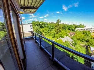 a balcony with a view of the forest at De Lita in Druskininkai