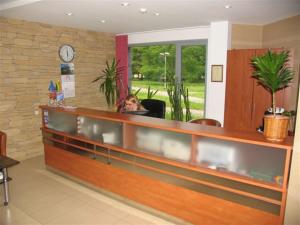 a woman sitting in a chair in a waiting room at Hotel Ode in Alytus