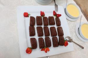 a plate of brownies and strawberries on a table at Magoebaskloof Getaway in Magoebaskloof