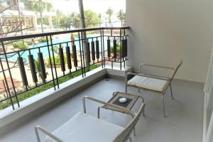a room with chairs, tables and a window at Welcome World Beach Resort & Spa in Pattaya South