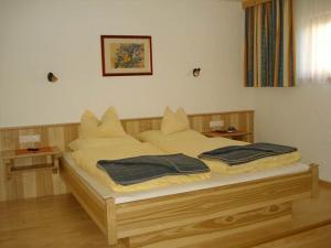 1 dormitorio con 1 cama con 2 almohadas en Appartements Stiererhof, en Ramsau am Dachstein