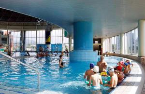 a group of people in a swimming pool at Apartment Alipašino in Sarajevo