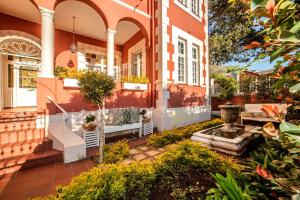 an exterior view of a house with a garden at The Villa Rosa Guest House & Self-catering Apartments in Cape Town