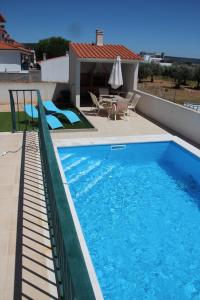 a swimming pool on the side of a house at Olive View in Vila Nova da Barquinha