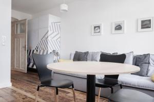 un tavolo e sedie in soggiorno con divano di Apartament BM a Danzica