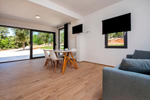 a living room with a table and chairs and a couch at Villa David in Rovinj