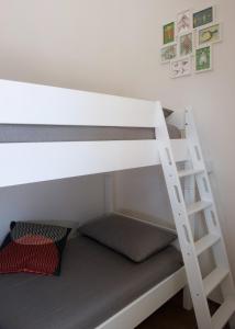 a bunk bed with a ladder on the bottom bunk at Via Del Faro Apartments in Torre Canne