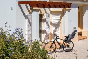 a bike parked in front of a house at NAU Salema Beach Village in Salema