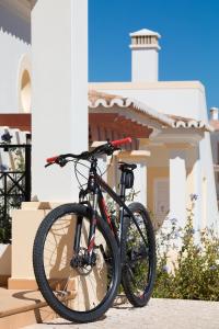 a bike parked in front of a house at NAU Salema Beach Village in Salema