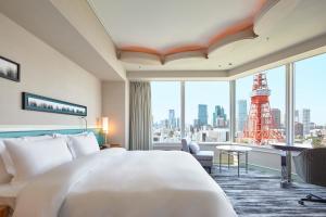 a hotel room with a bed and a view of the eiffel tower at The Prince Park Tower Tokyo - Preferred Hotels & Resorts, LVX Collection in Tokyo