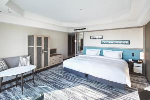 a hotel room with a large bed and a couch at The Prince Park Tower Tokyo - Preferred Hotels & Resorts, LVX Collection in Tokyo