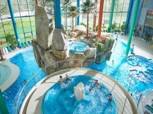 um escorrega aquático num parque aquático com pessoas nele em Aqua Center Apartments em Druskininkai