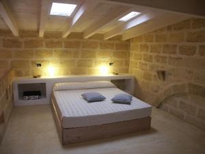 a bedroom with a bed with two pillows on it at B&B Masseria Dei 12 Granai in Minervino di Lecce