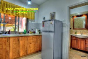 a kitchen with a refrigerator and a sink at Country lodging in Manot in Manot