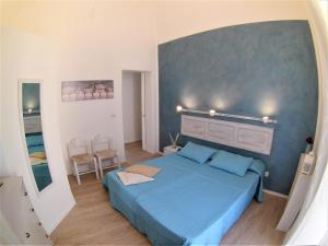 Un dormitorio con una cama azul con luces encima. en Duomo Sant'Agata Apartments en Catania