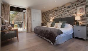 a bedroom with a bed and a dresser at Mill End Hotel in Chagford