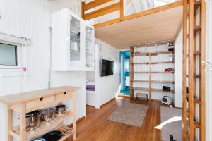 a kitchen with white cabinets and a wooden table at Beach house in Oslo in Oslo