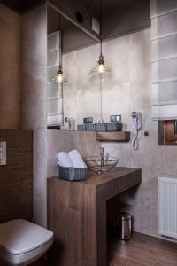 a bathroom with a sink and a toilet at Apartamenty Willa w Dolinie in Tarnów +42 photos