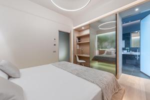 a bedroom with a white bed and a desk at Air Suite Verona in Verona