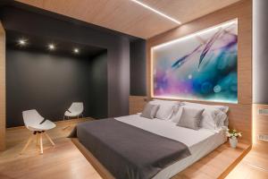 a bedroom with a bed and a painting on the wall at Air Suite Verona in Verona