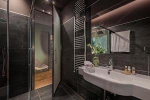a bathroom with a sink and a shower at Air Suite Verona in Verona