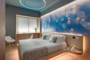 a bedroom with a bed and a blue painting on the wall at Air Suite Verona in Verona