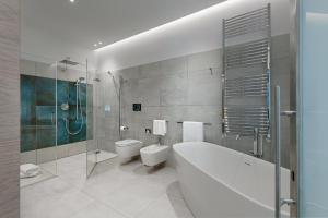 a bathroom with a tub and a toilet and a shower at Air Suite Verona in Verona +13 photos