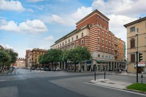 an empty city street with a tall brick building at Air Suite Verona in Verona