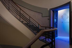 a staircase in a building with a blue light at Air Suite Verona in Verona