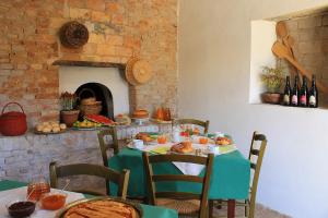 a table with plates of food and bottles of wine at La Peschiera B&B in San Lorenzo del Vallo