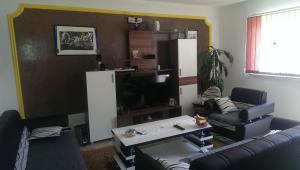 a living room with a couch and a tv at Apartman Ela in Bihać