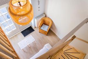 an overhead view of a staircase in a house with a chandelier at Slapen aan de Bosweg in Zoutelande +24 photos
