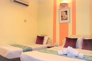 Postel nebo postele na pokoji v ubytování Sun Inns Hotel Puchong