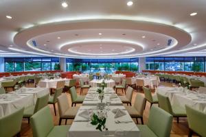a dining room with white tables and chairs at TUl BLUE Side Adult Only 16 Plus - Ultra All Inclusive in Side